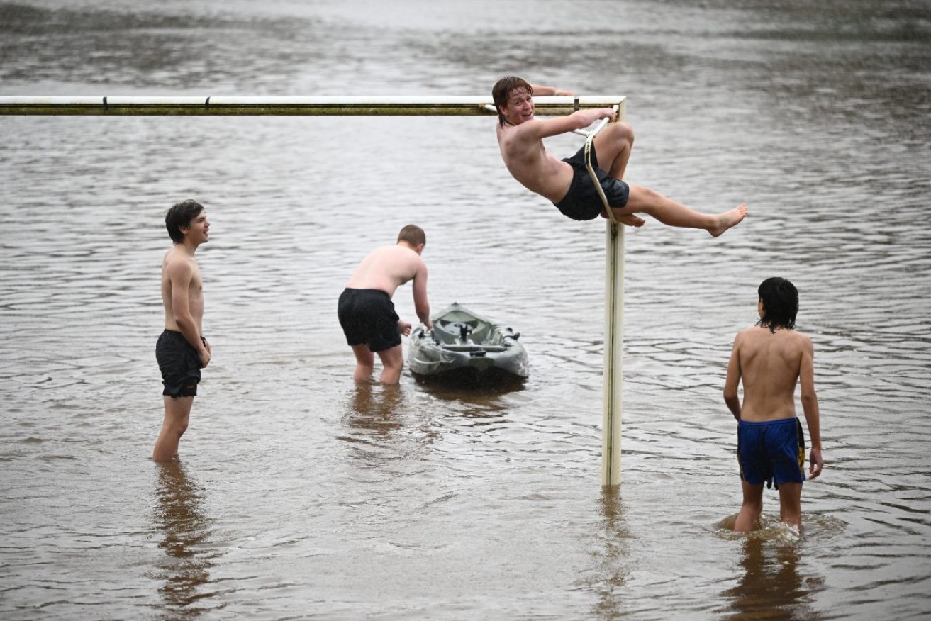 People are seen canoeing and swimming on the soccer ovals at Strathdale Park in Bendigo, Victoria. Photo: AAP/James Ross
