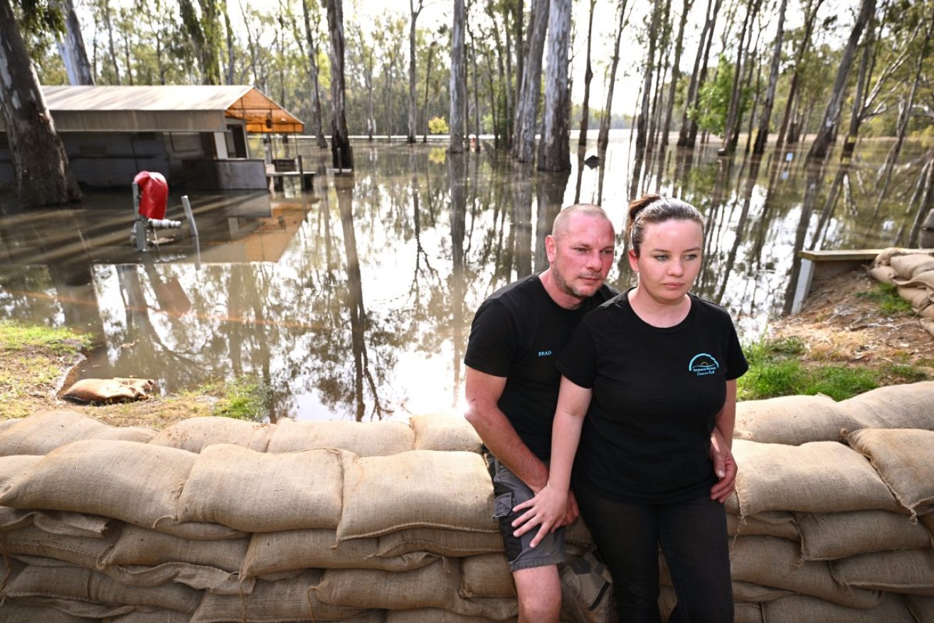 Owners Brad and Jenni Panos at the Barmah Bridge Caravan Park in Barmah, Victoria. The ADF has been called in to help flood victims in Victoria, with authorities predicting more than 7500 proprieties could be impacted. Photo: AAP/Joel Carrett.