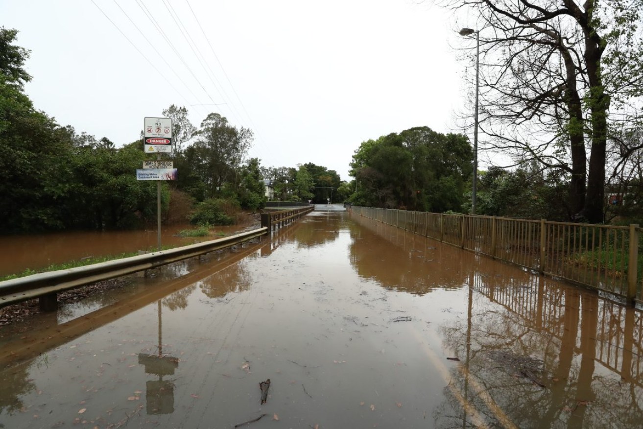 A flooded bridge at Lismore in NSW on Monday. Photo: AAP/Jason O'Brien