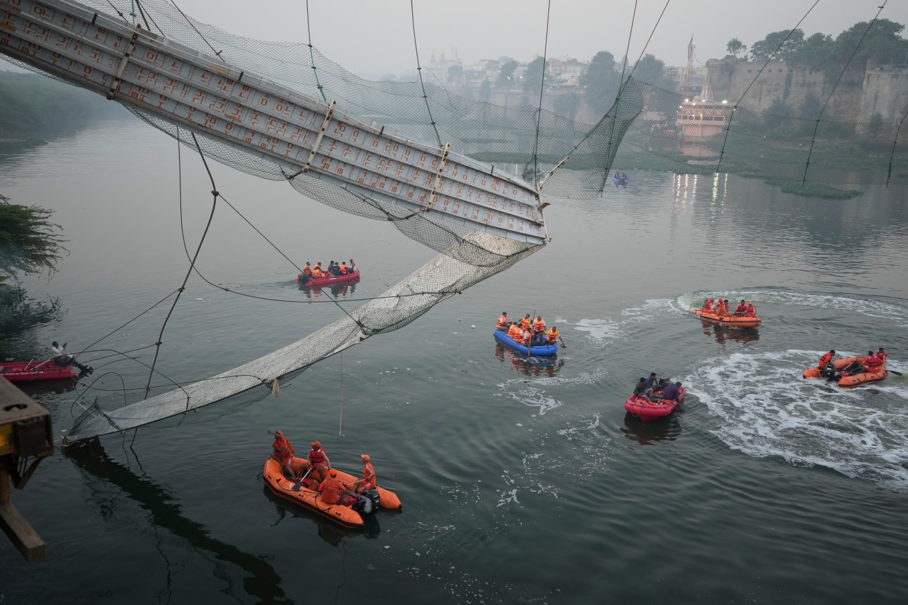 A cable suspension bridge after its collapse in India. Photo: AP/Ajit Solanki