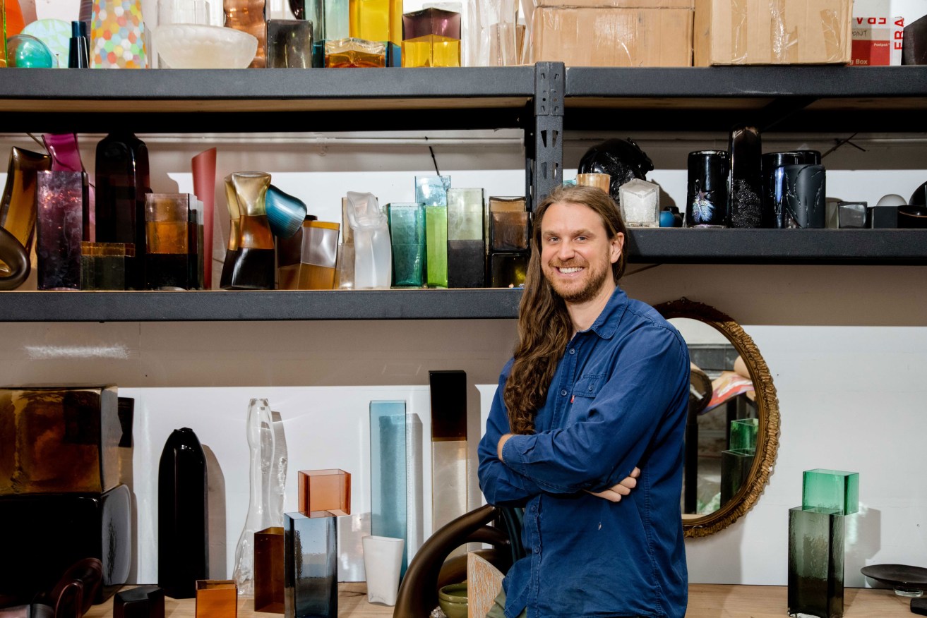 Liam Fleming with some of his work in the Queen’s Court studio he shares with two other glass artists. Photo: Jack Fenby