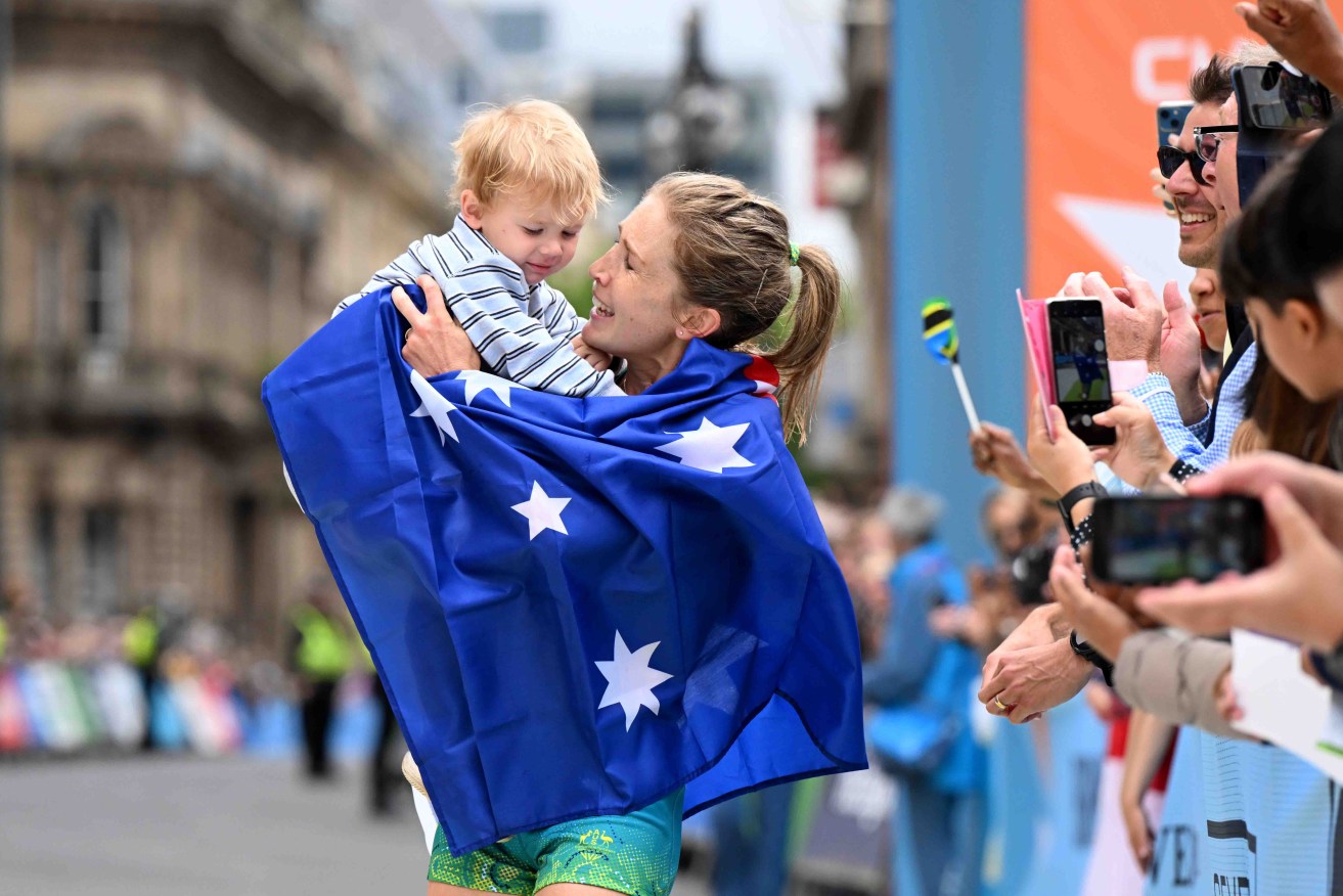 Jessica Stenson celebrates her Commonwealth Games gold medal with son Billy in July. Photo: AAP/Darren England