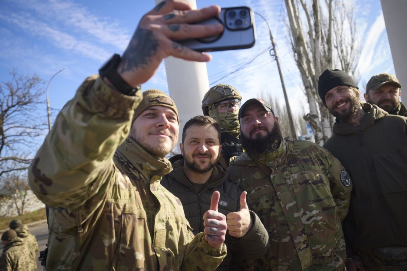 Ukrainian soldiers take a selfie with President Volodymyr Zelenskyy during his visit to Kherson. Photo: Ukrainian Presidential Press Office via AP