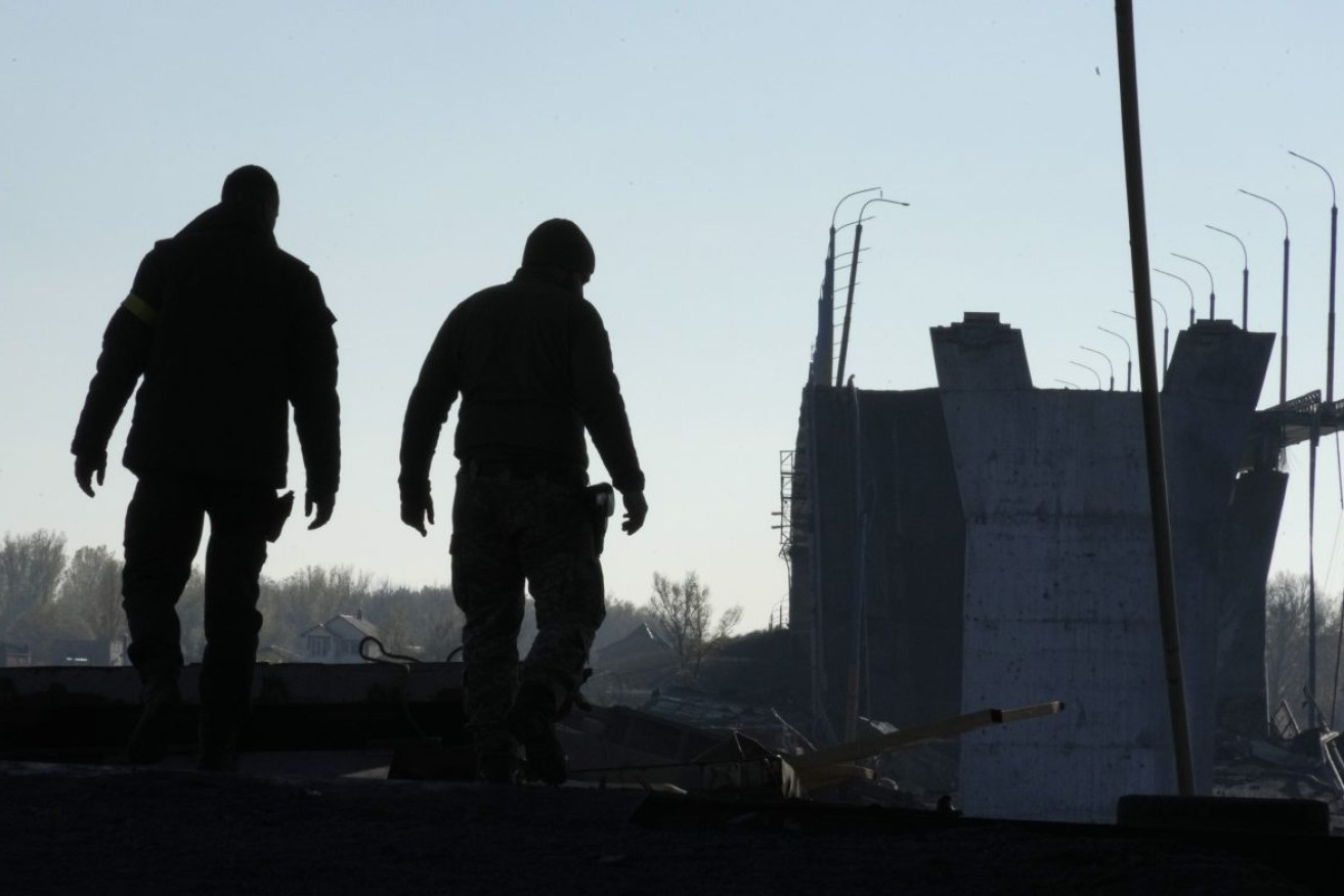 Ukrainian soldiers inspect damaged Antonovsky bridge over the Dnieper river in Kherson, Ukraine. Photo: AP/Efrem Lukatsky