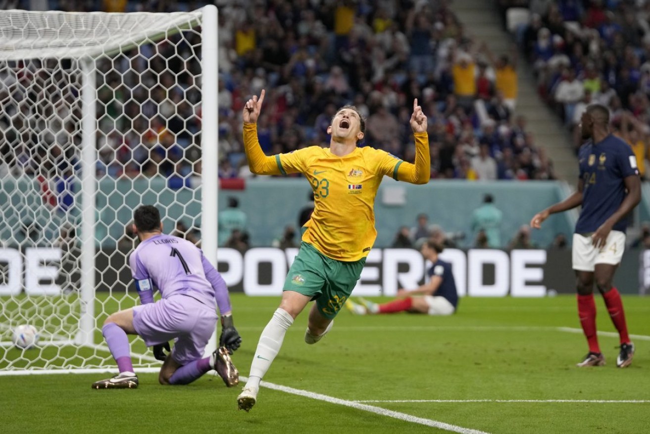 Australia's Craig Goodwin celebrates after scoring the opening goal against France. Photo: AP/Thanassis Stavrakis