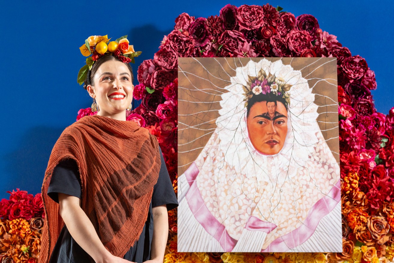 Frida Kahlo enthusiast Jacqueline Feronas with a reproduction of Kahlo’s 'Diego on my Mind' at the announcement of 'Frida & Diego: Love & Revolution' at the Art Gallery of South Australia. Photo: Saul Steed