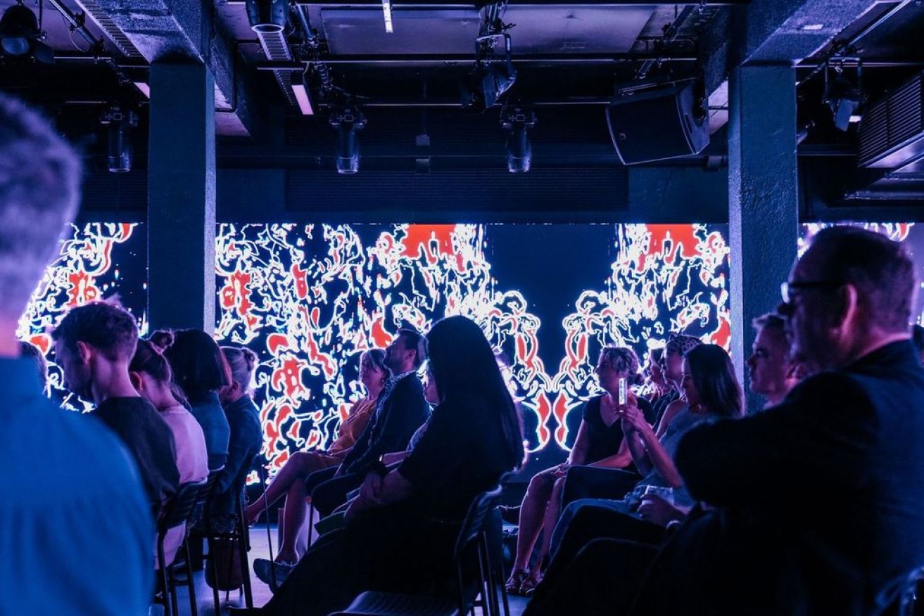 Audience members at a show at The Lab, surrounded by visual elements on the venue's large LED screens. Photo: Jack Fenby 