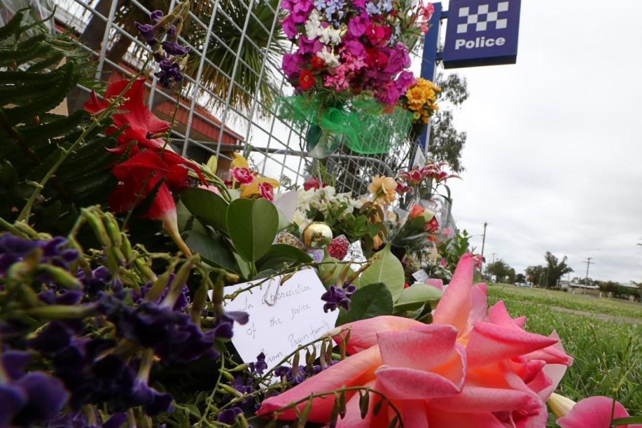 Tributes outside an outback Queensland police station after two officers were shot dead. Photo: AAP Image/Jason O'Brien