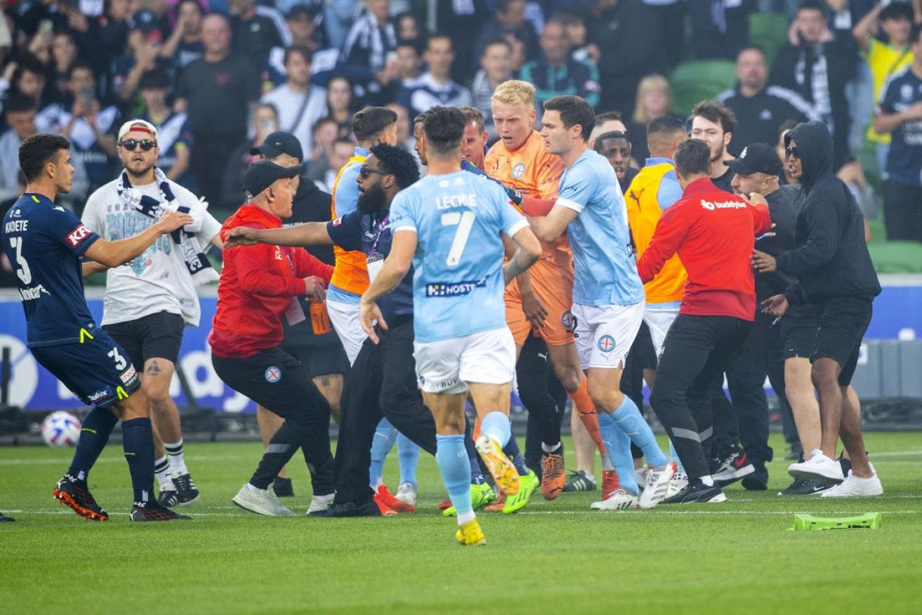 Melbourne Victory fans invade the pitch during the A-League match against Melbourne City. Photo: AAP/Will Murray