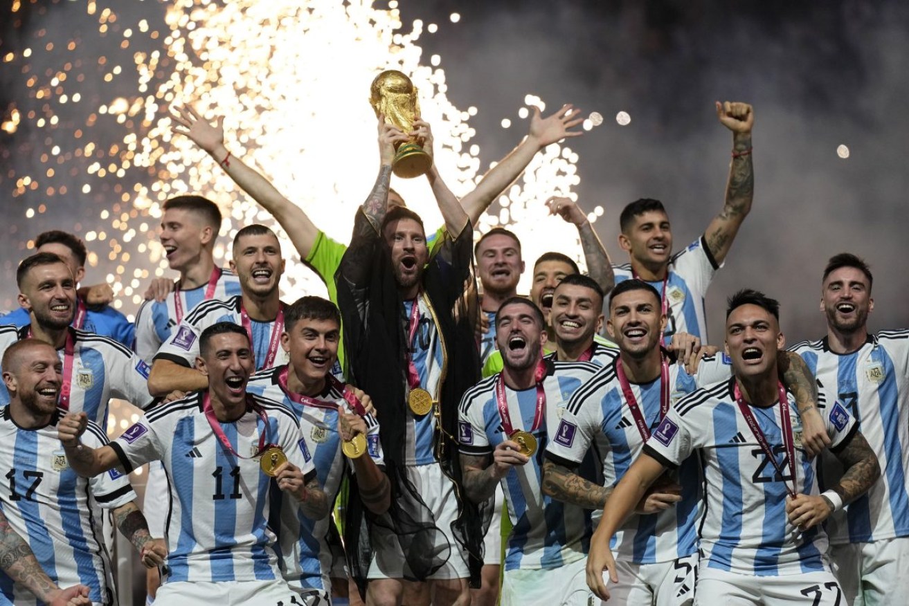 Argentina's Lionel Messi lifts the trophy after winning the World Cup final. Photo: AP/Martin Meissner