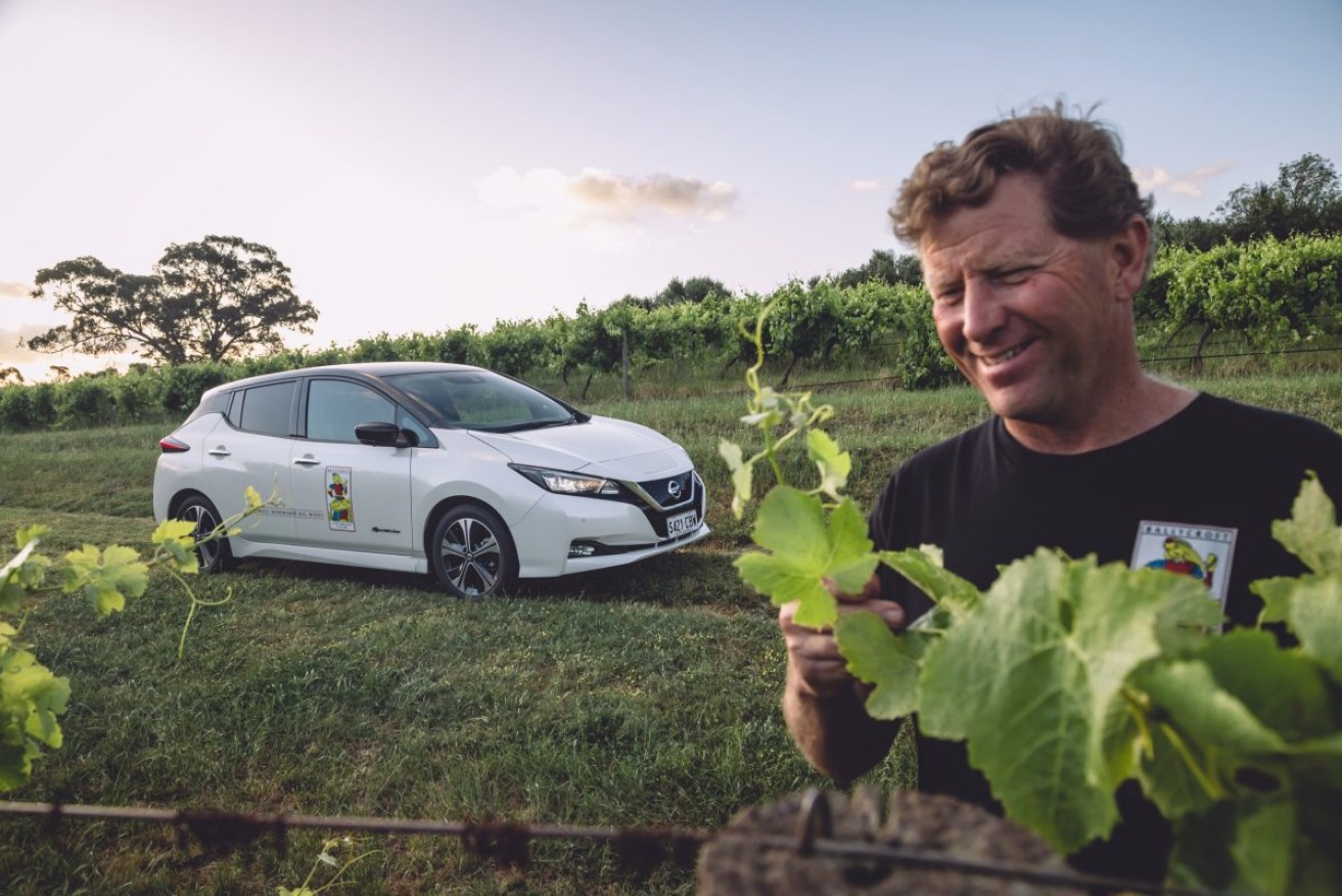 Ballycroft Vineyard's Joseph Evans with his electric car at Greenock in the Barossa. Photo: AAP/supplied