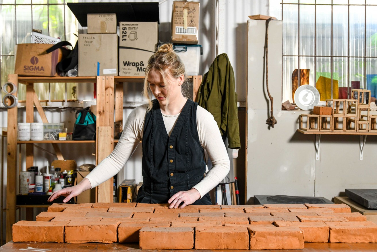 Bernadette Klavins in her Norwood studio with a set of bricks that were connected to an exhibition exploring the impact of humans as geologic agents. Photo: Jack Fenby / InReview