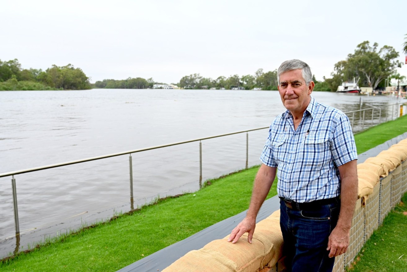 Renmark Mayor Peter Hunter inspects barriers which protected the town from River Murray flooding. He's now calling for urgent mental health services to help struggling locals. Photo: Belinda Willis