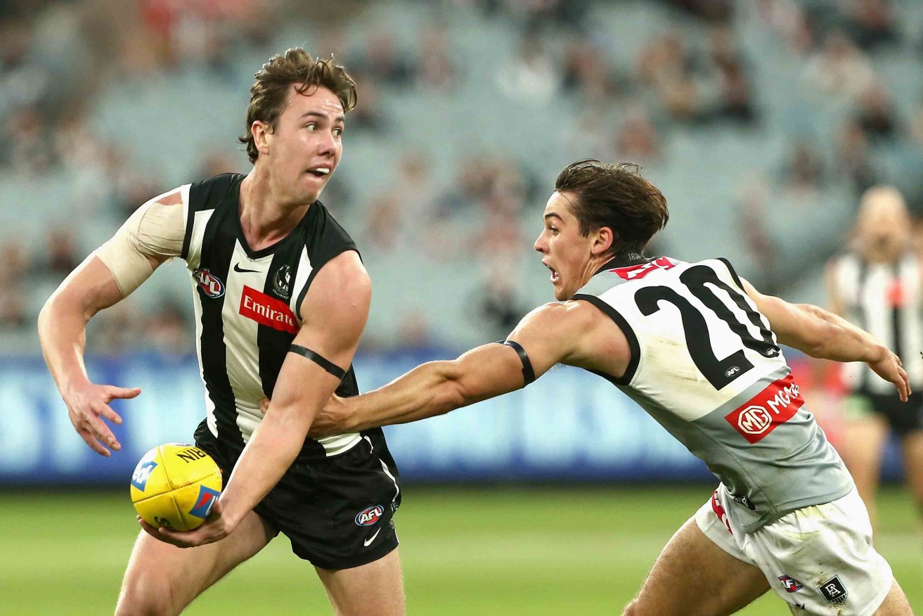 Tyler Brown (left) in action for Collingwood against Port Adelaide in 2021. Photo: AAP/Rob Prezioso