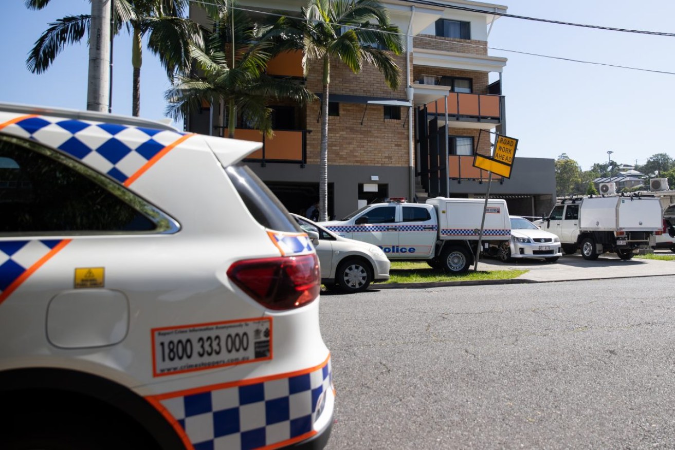 Police at the apartment block after the body was found on December 7. Photo: AAP/Russell Freeman