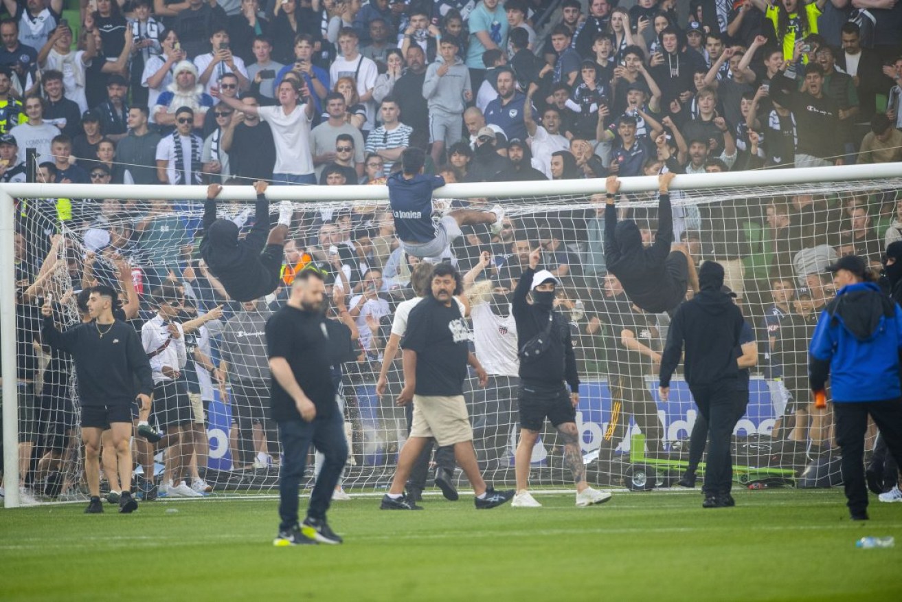 Melbourne Victory fans invade the pitch. Photo: AAP/Will Murray