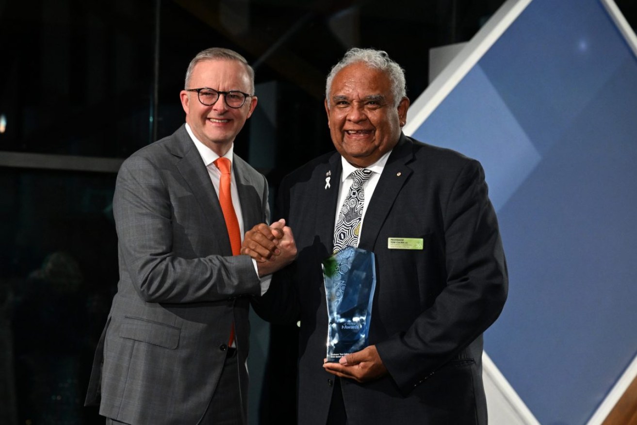 Prime Minister Anthony Albanese and 2023 Senior Australian of the Year Tom Calma pose for photos at the National Arboretum in Canberra. Photo: AAP/Mick Tsikas