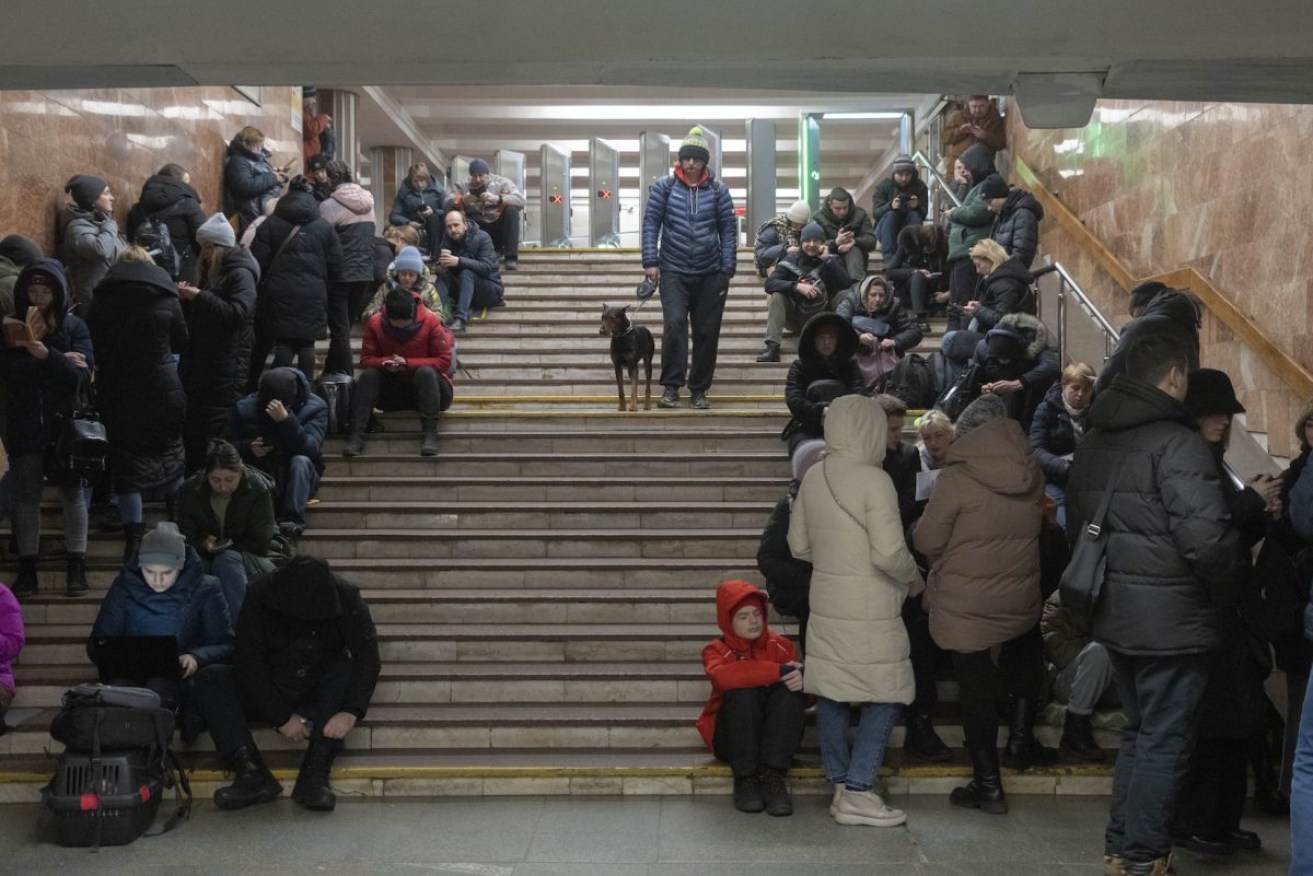 People gather in a subway station being used as a bomb shelter during a Russian rocket attack in Kyiv, Ukraine. Photo: AP/Efrem Lukatsky