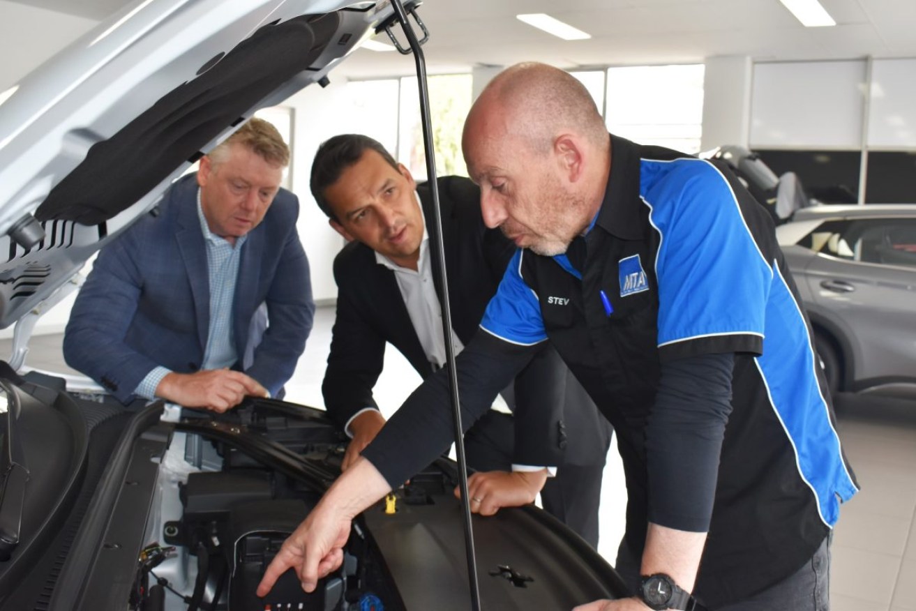 Left to right: MTA CEO Darrell Jacobs, Minister Blair Boyer and MTA head trainer Steve Richardson at BYD Medindie, an EV dealership. Supplied image