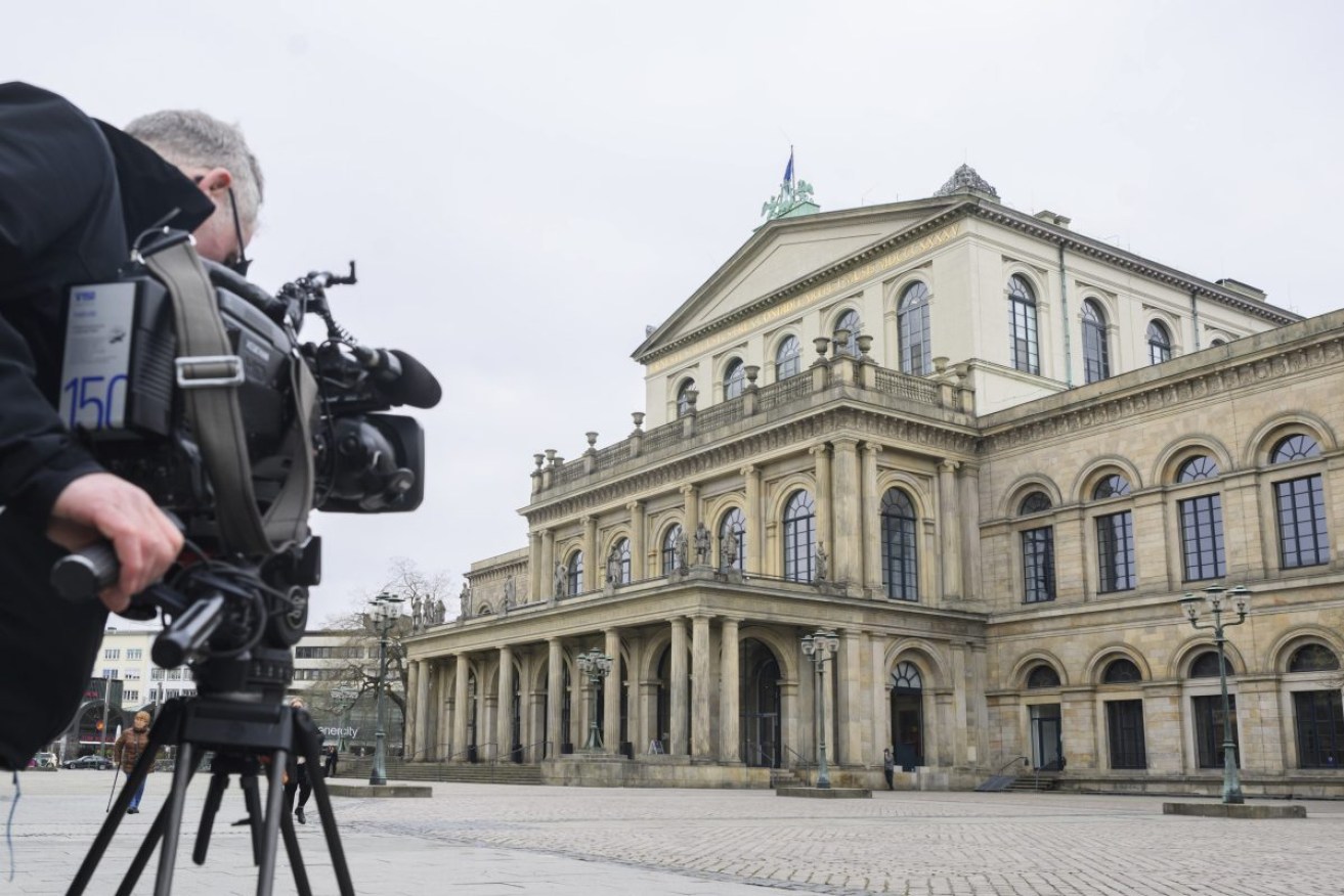 A TV cameraman films the State Opera in Hanover, Germany after a newspaper critic was assaulted with animal faeces. Photo: Julian Stratenschulte/dpa via AP