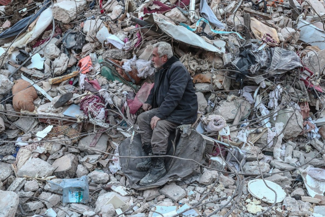 A man awaits news about his family in the rubble of Hatay, Turkey. Photo: EPA/SEDAT SUNA