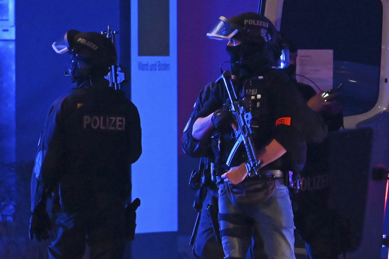 Armed police officers near the scene of the shooting in Hamburg. Photo: Jonas Walzberg/dpa via AP