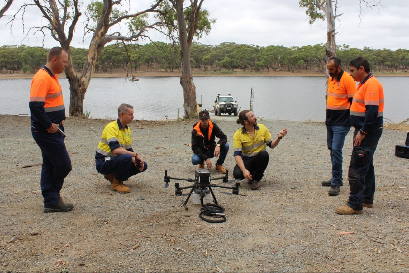 SA Water officials preparing a drone to take water samples in Happy Valley reservoir. Photo: SA Water/supplied