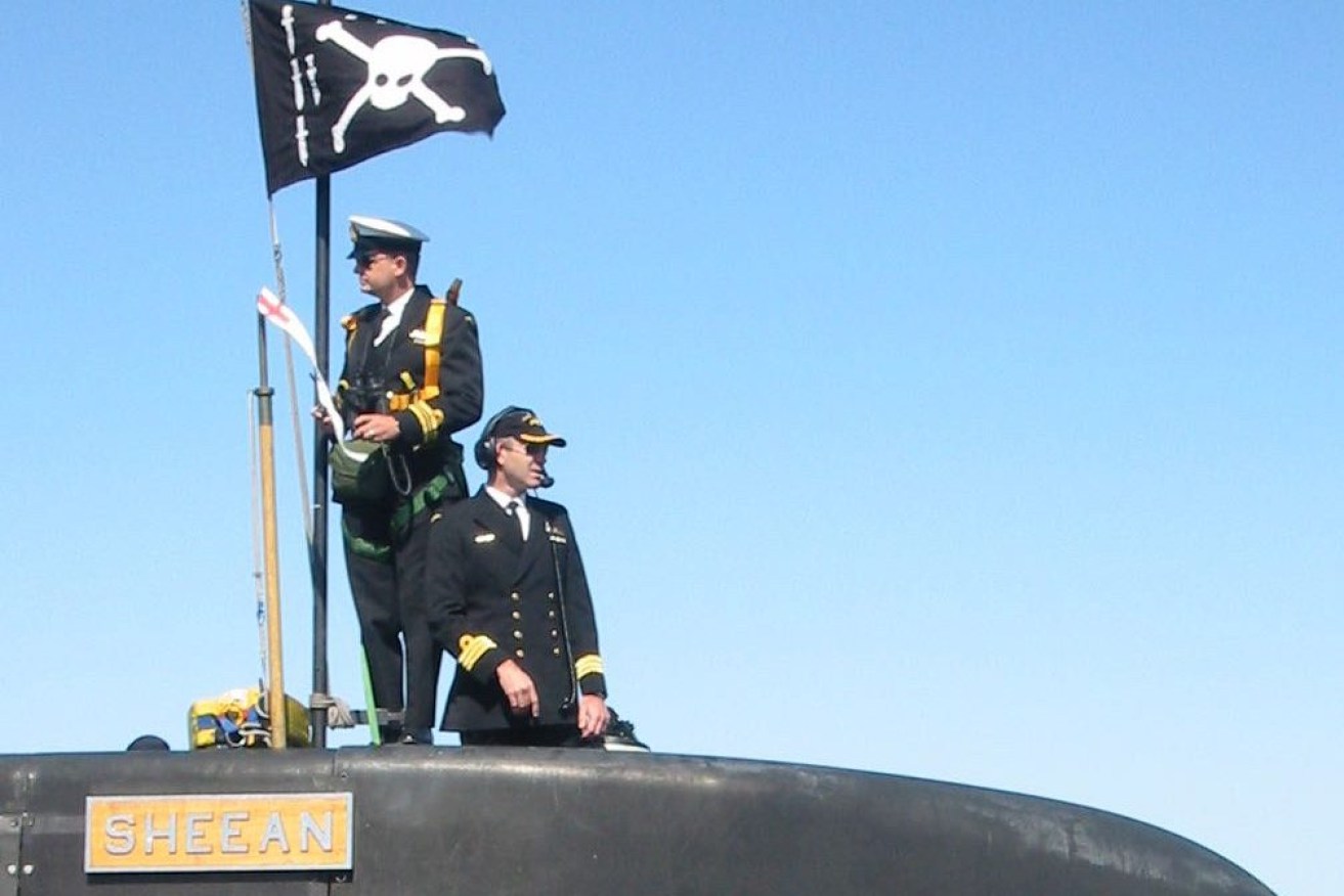 Former HMAS Sheean submarine commander Andy Keough (right). The skull and crossbones flag is flown on return from operations. Photo: supplied