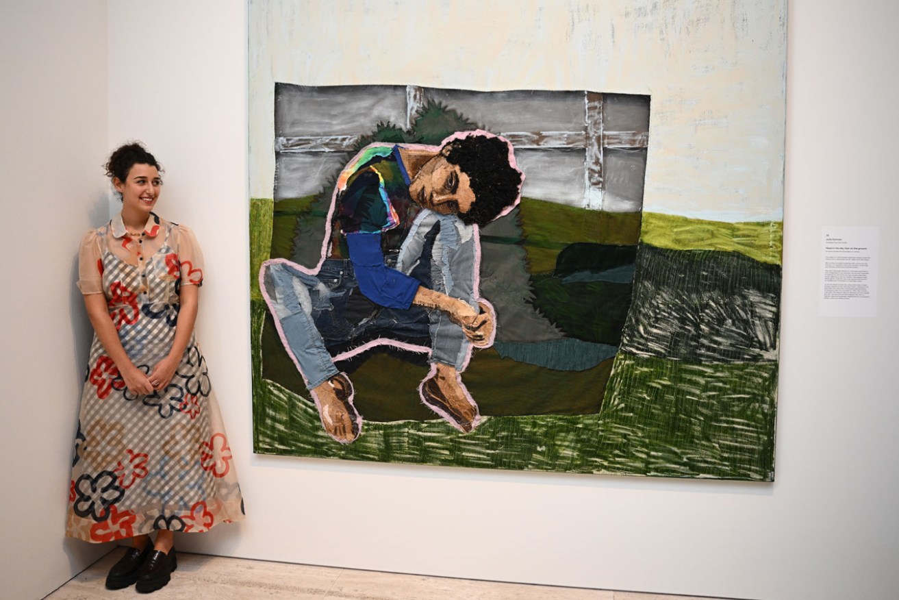 2023 Archibald Prize winner Julia Gutman with her portrait of Montaigne titled 'Head in the sky, feet on the ground' at the Art Gallery of New South Wales in Sydney. Photo: Dan Himbrechts / AAP