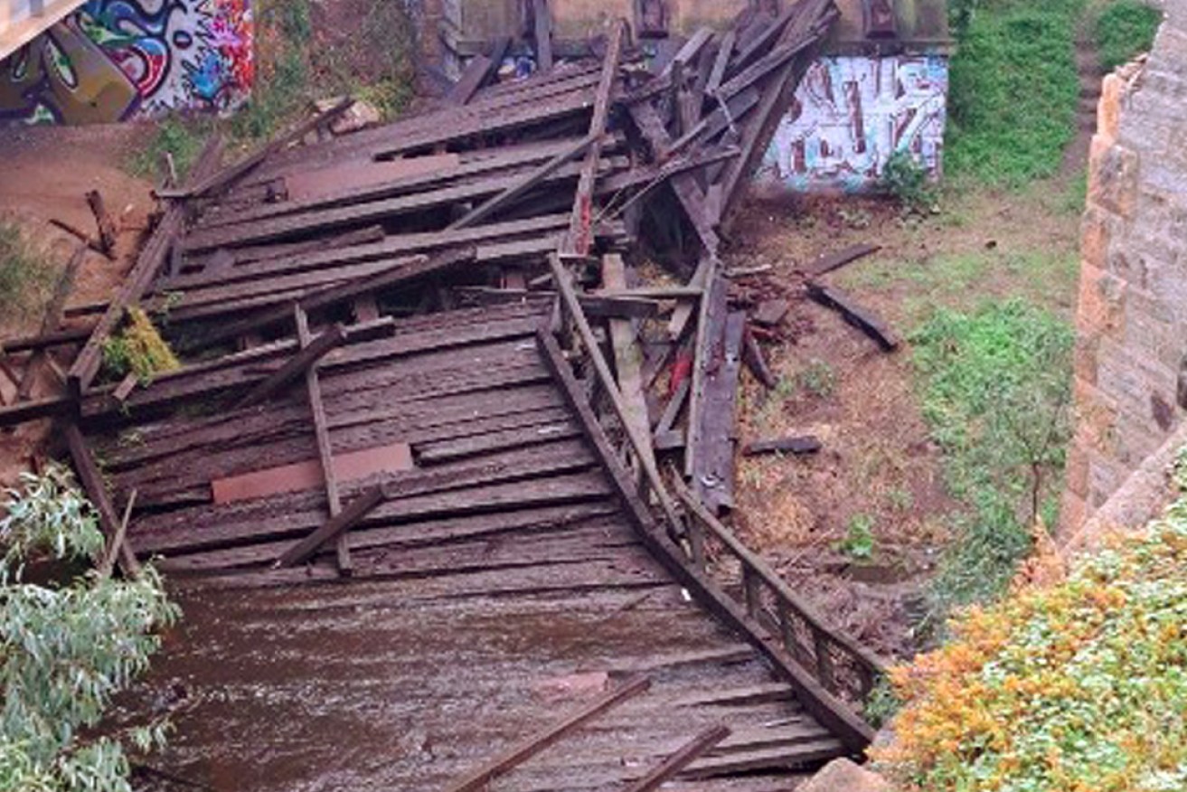 The 1876-built Angle Vale Bridge has collapsed into the Gawler River. Photo: Light Regional Council