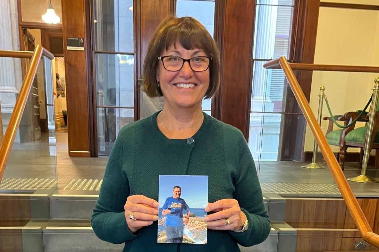 Andrea Fuller holding a picture of her father Dion Manthorpe who died peacefully under new voluntary assisted dying laws. Photo: supplied