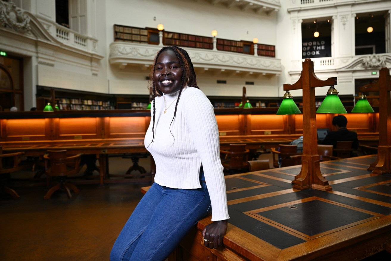 Author Kgshak Akec at the State Library in Melbourne. Photo: Joel Carrett / AAP 