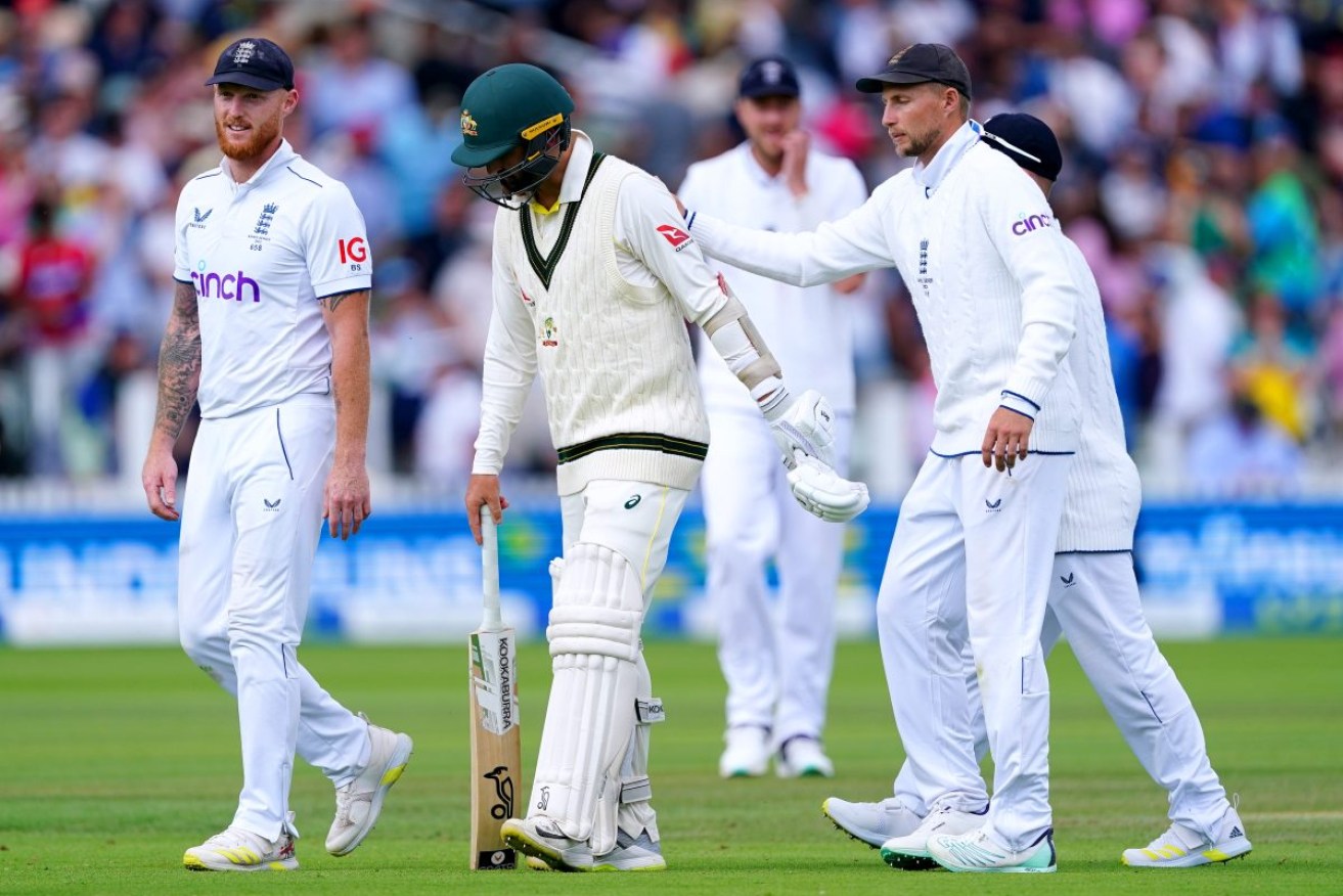Australia's Nathan Lyon is patted on the back by England's Joe Root after batting while injured. Photo: Mike Egerton/PA Wire. 