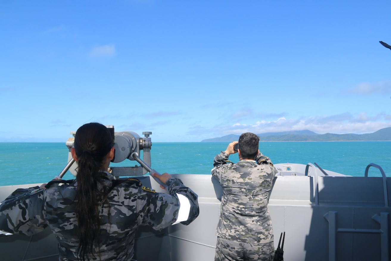 Royal Australian Navy sailors from HMAS Brisbane scan the horizon during search and rescue operations in the vicinity of Lindeman Island. Photo AAP