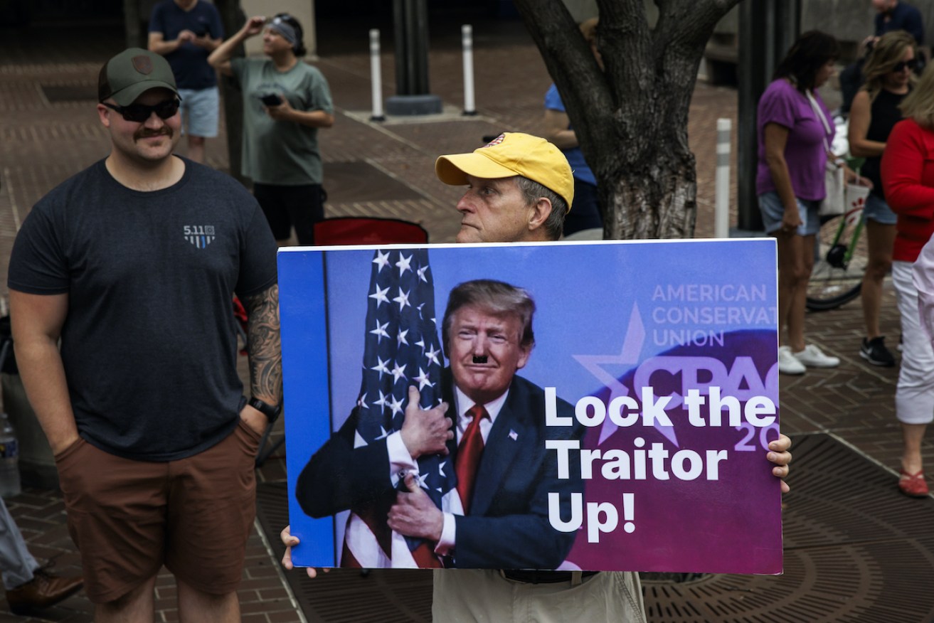 A protestor outside the Washington, DC courthouse where former President Donald Trump appeared charged with four criminal counts of using "unlawful means of discounting legitimate votes and subverting the election results". Photo: Samuel Corum/Sipa USA