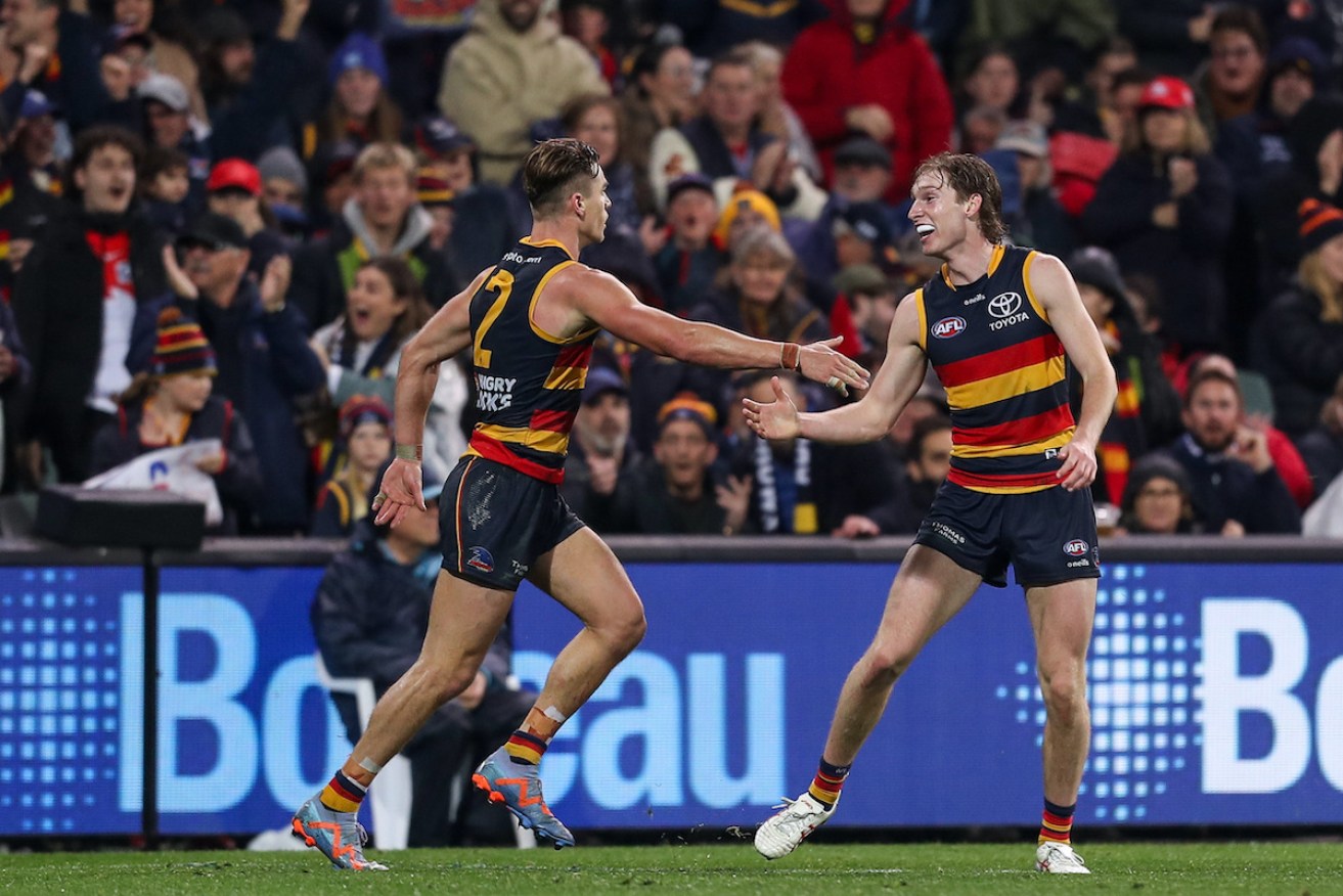 Ben Keays (left) celebrates what he thought was the winning goal against Sydney, but was mistakenly ruled a point. Photo: AAP/Matt Turner