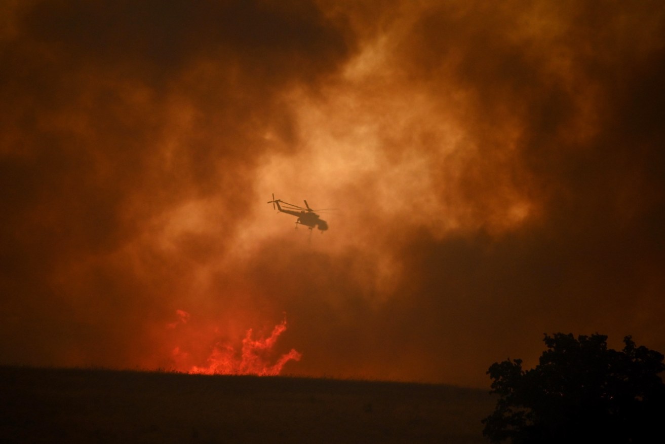 A firefighting helicopter at the village of Avantas near the city of Alexandroupolis in northern Greece. Photo: EPA/DIMITRIS ALEXOUDIS