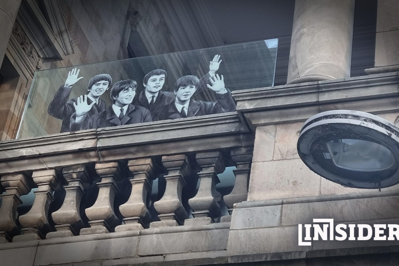An estimated 30,000 people gathered on King William St to greet the Beatles at Town Hall in 1964. The moment was commemorated with this piece of glass artwork in 2016. Photo: InDaily