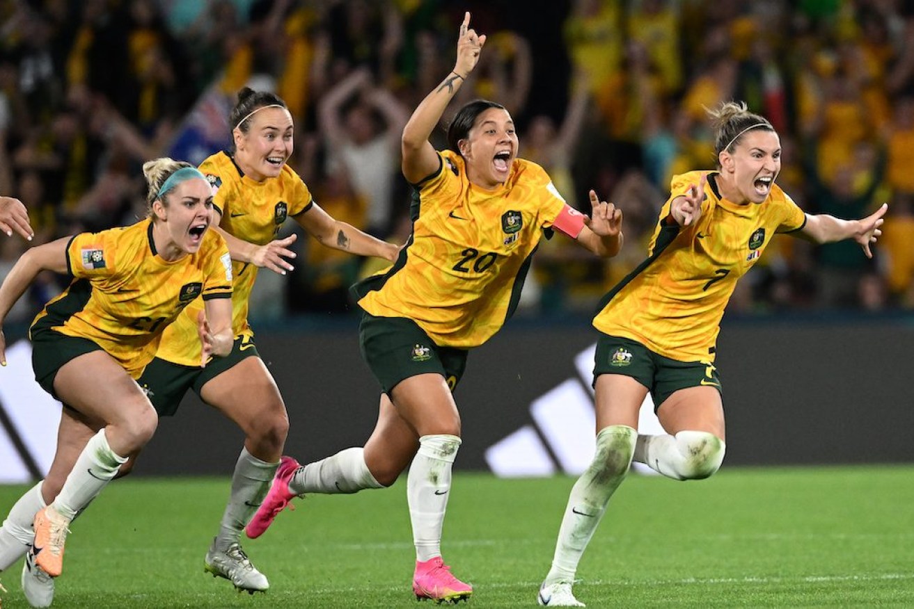 (Left to right) Ellie Carpenter, Caitlin Foord, Sam Kerr and Steph Catley of Australia celebrate winning after Cortnee Vine of Australia kicked a successful penalty goal to defeat France in the FIFA Women's World Cup 2023 Quarter Final soccer match between Australia and France at Brisbane Rectangular Stadium in Brisbane on Saturday. Photo: AAP Image/Darren England 