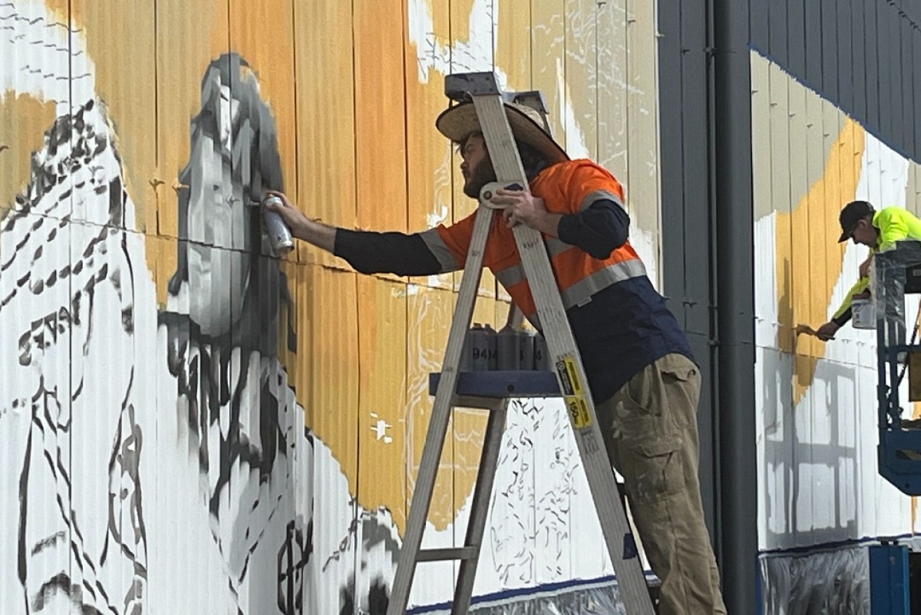 Sam Brooks (foreground) and Mark Harding will complete the Port Pirie aerodrome  mural by the end of August.