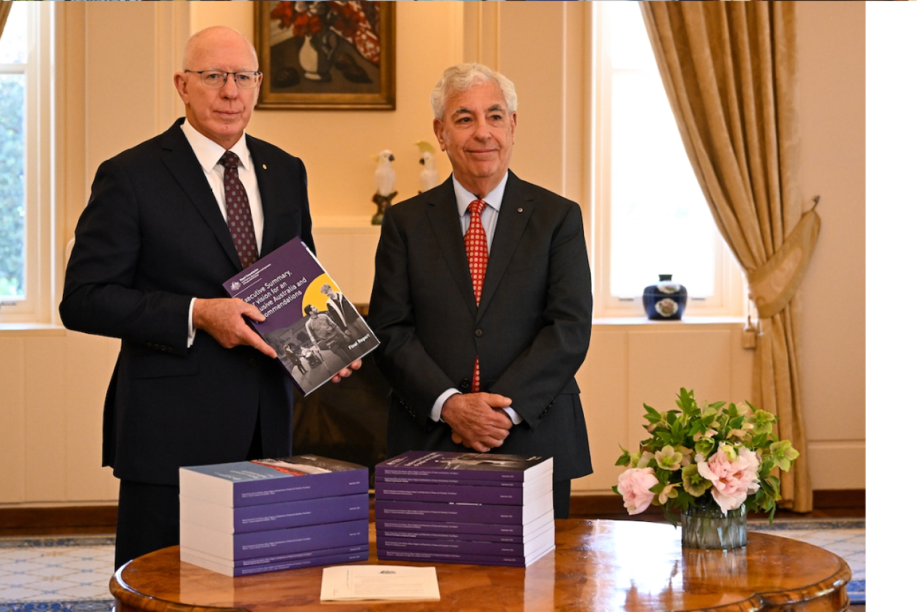 Governor-General David Hurley and disability royal commission chair Ronald Sackville with the final report. Photo: AAP/Lukas Coch