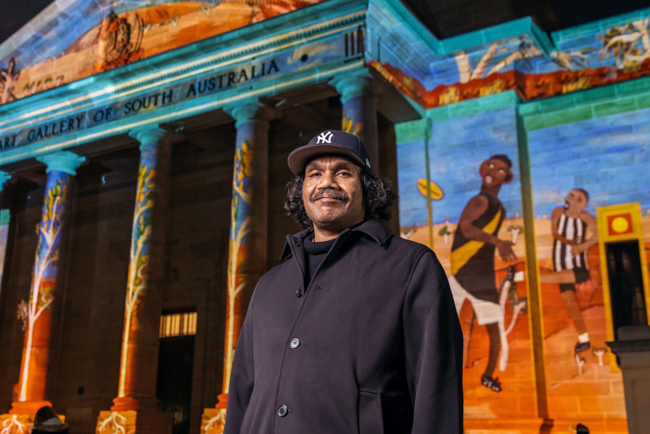 Vincent Namatjira with his work 'Going Out Bush', projected on the Art Gallery of South Australia facade during Illuminate Adelaide 2022. Photo: Sia Duff / supplied