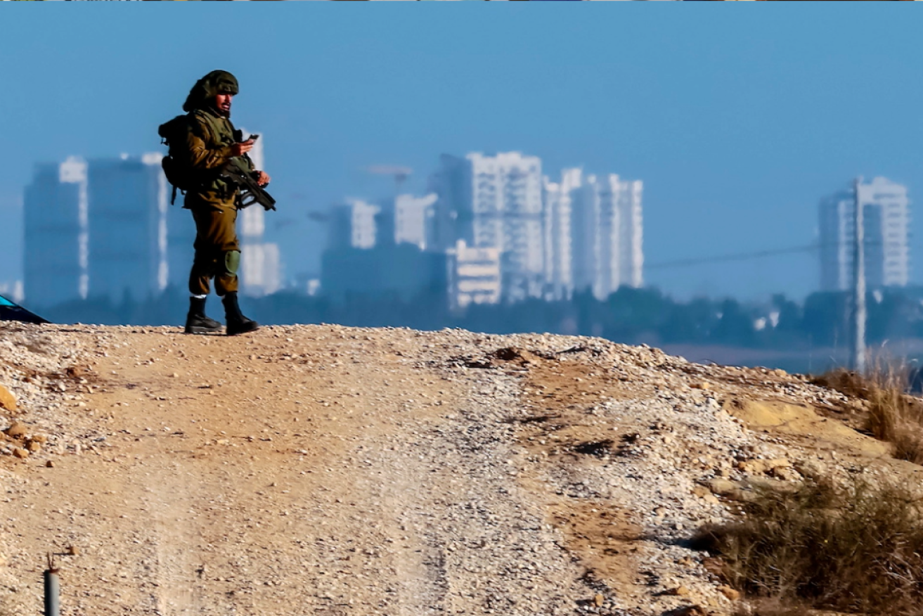 An Israeli soldier patrols on a road near the Gaza strip. Photo: Hannibal Hanschke/EPA
