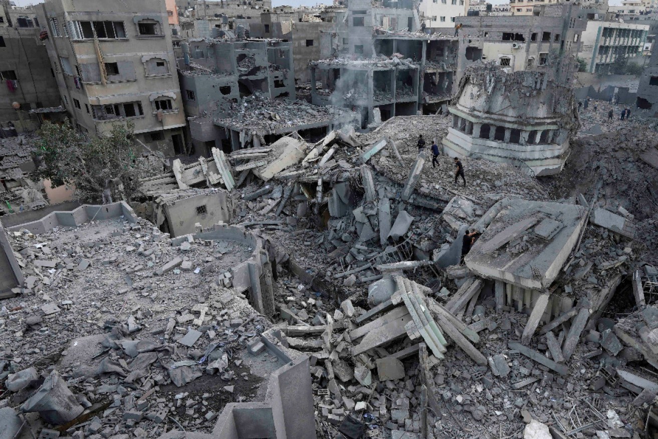 Israeli strikes have destroyed buildings in Gaza as officials said the area would pay a heavy price. Photo: EPA