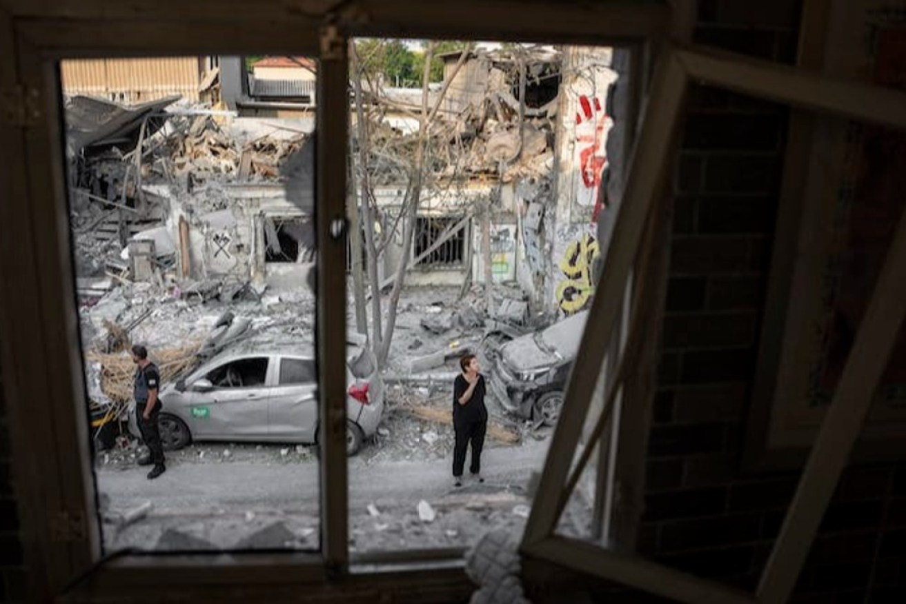 Israelis inspect the rubble of a building in Tel Aviv on Oct. 8, 2023, a day after it was hit by a rocket fired from the Gaza Strip.
Photo: AP Photo/Oded Balilty