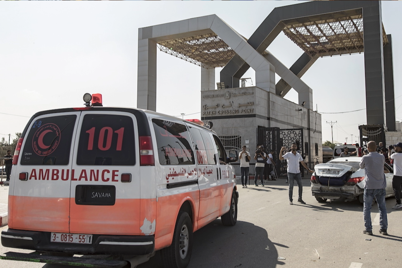 An ambulance with wounded Palestinians arrives at the Rafah border crossing between the Gaza Strip and Egypt. Photo: Haitham Imad/EPA 