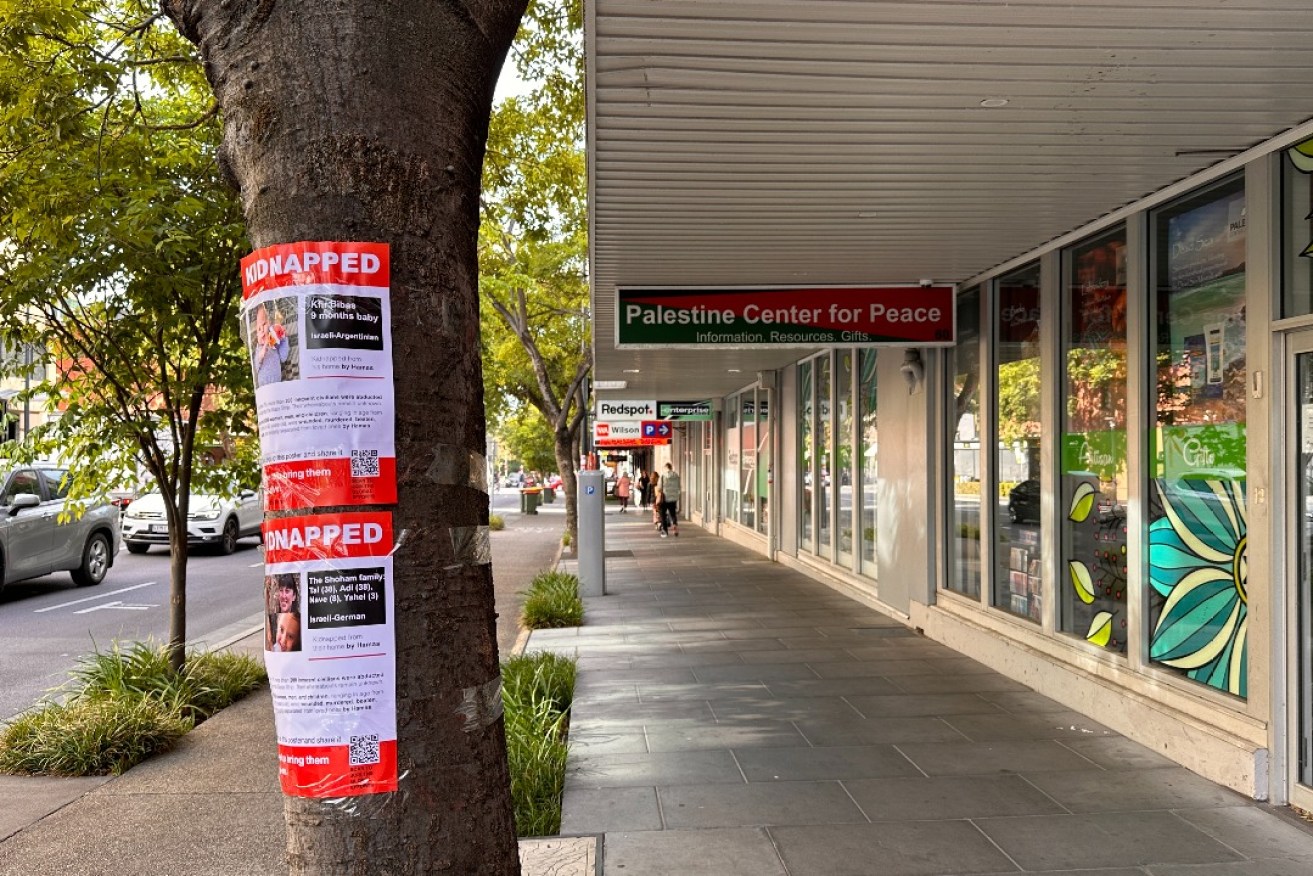 Anti-Hamas posters on a tree near the Palestinian Centre for Peace. Photo: David Simmons/InDaily.