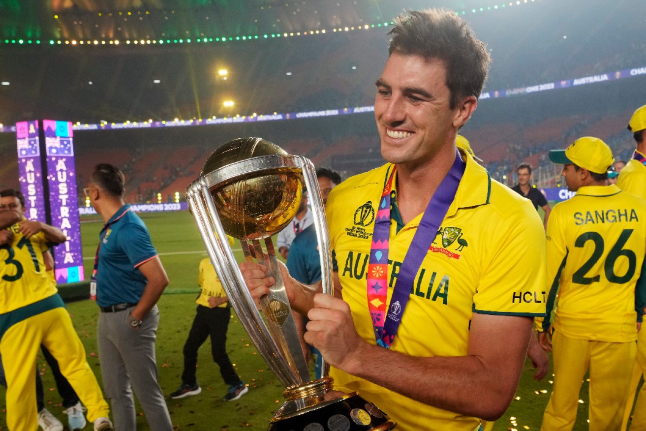 Australian captain Pat Cummins with the World Cup trophy. Photo: AP/Rafiq Maqbool 