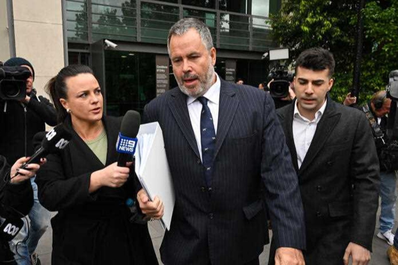 Lawyer Bill Doogue (centre) departs from the Latrobe Valley Law Courts in Morwell, Victoria. Photo: AAP/James Ross