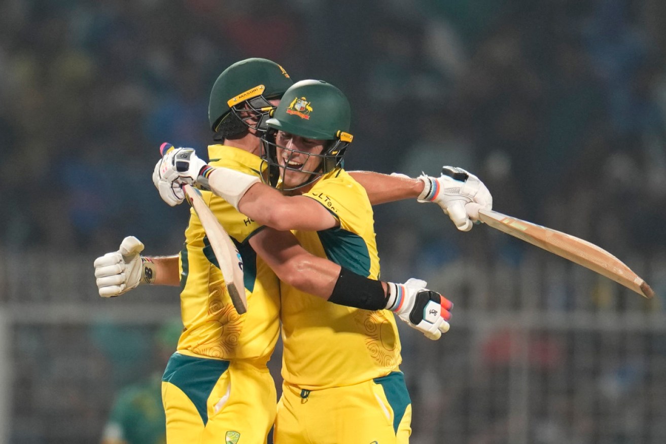 Australia's captain Pat Cummins and Mitchell Starc celebrate their win against South Africa. Photo: AP/Aijaz Rahi